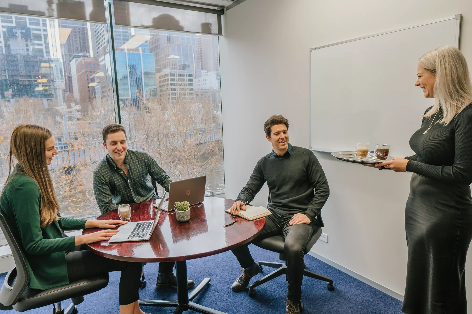 Group of clients working in a private fully fitted serviced office in a modern space with impressive views in Servcorp Southbank Melbourne