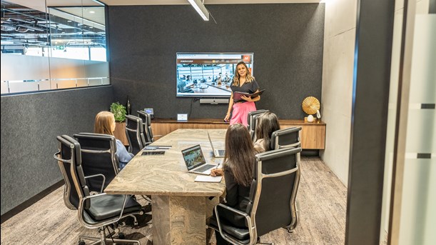 A team of corporate workers using a conference room