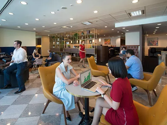 Clients working in a modern coworking space and enjoying the lounge in Servcorp Avaya House, Macquarie Park