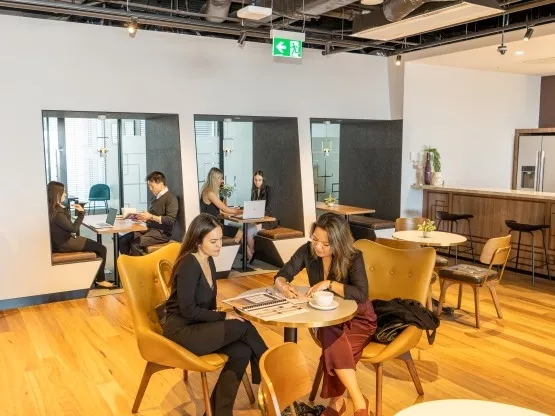 A group of clients operating in modern coworking space and booths in Servcorp 100 Mount Street