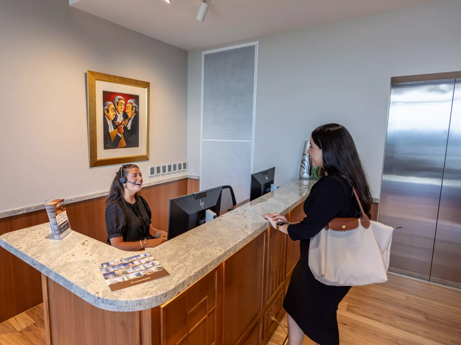 A client conversing with a dedicated receptionist in Servcorp 263 William Street, Melbourne