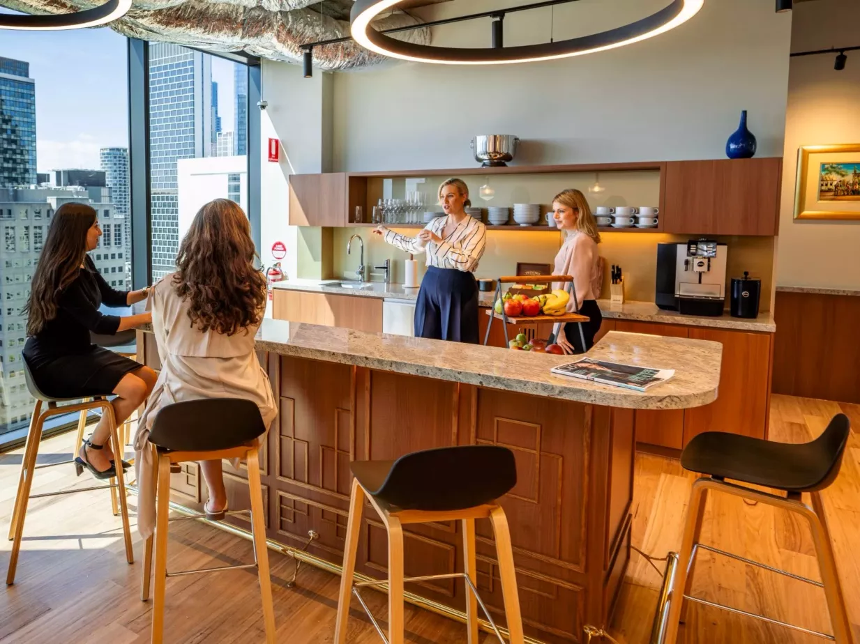 Clients in a modern coworking space enjoying fully stocked kitchen in Servcorp 263 William Street, Melbourne