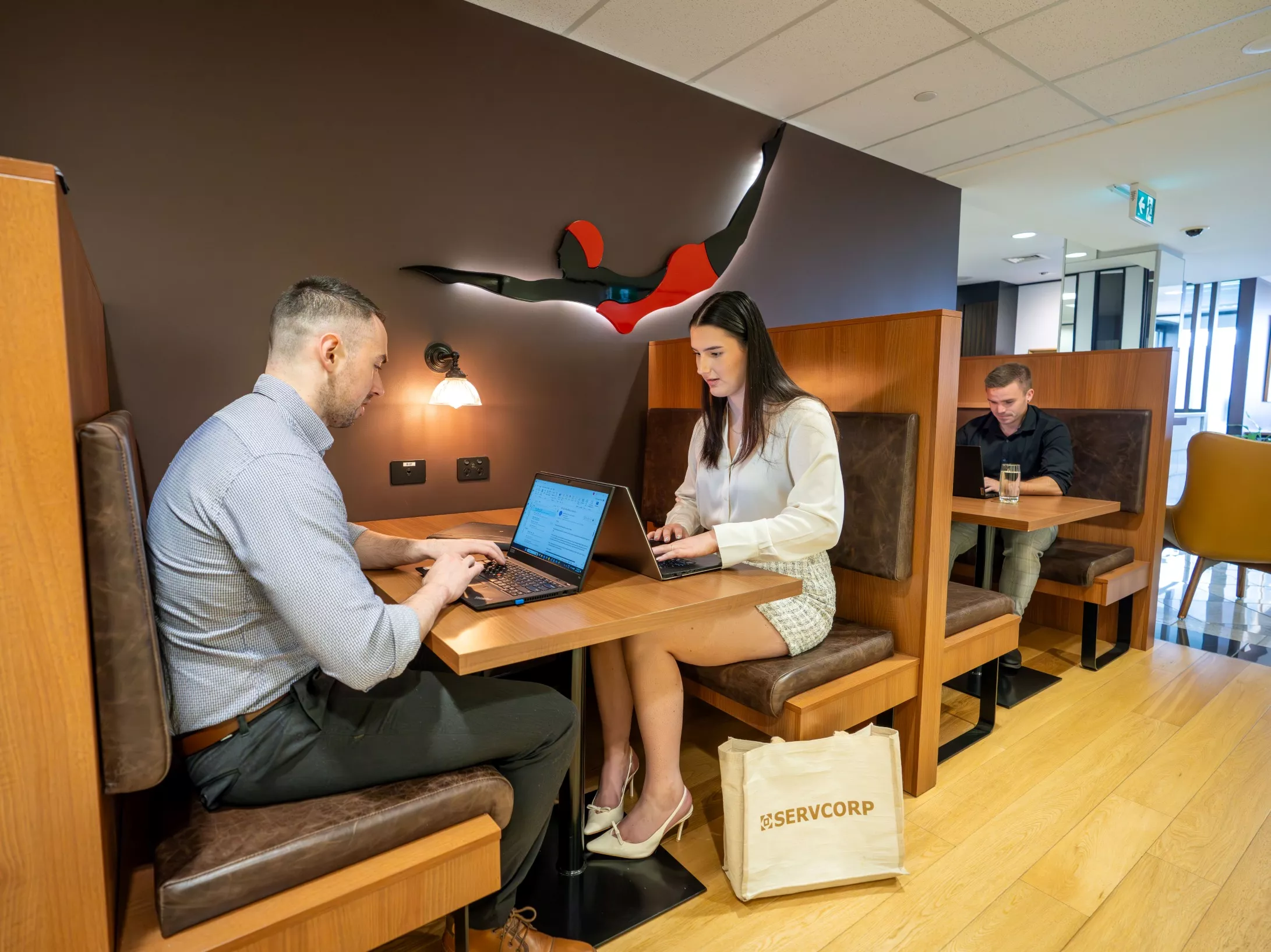 Clients working in a modern coworking booths in Servcorp Reserve Bank Building, Hobart