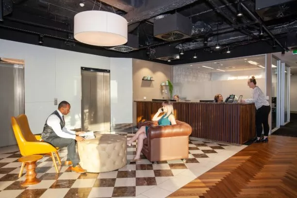 Clients working and enjoying the lounge in a modern coworking shared space in Servcorp 91 King William Street, Adelaide