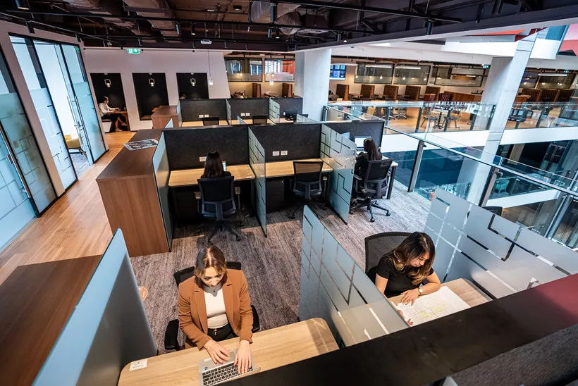 High angle of people enjoying their time in a modern coworking space working on dedicated desks in Servcorp 3 Parramatta Square