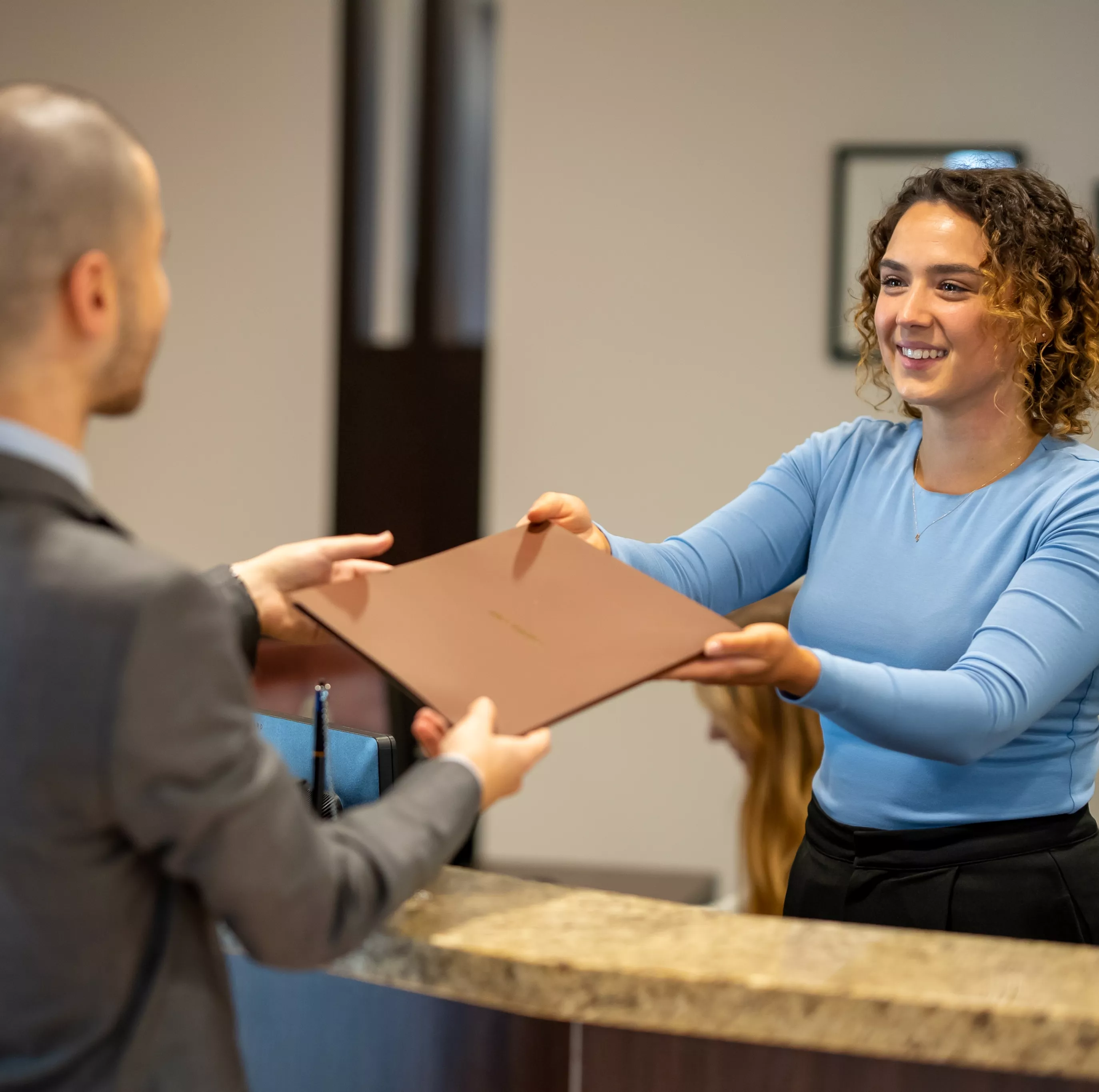 close up on people exhanging in the reception in a modern coworking space in Barangaroo, tower 1