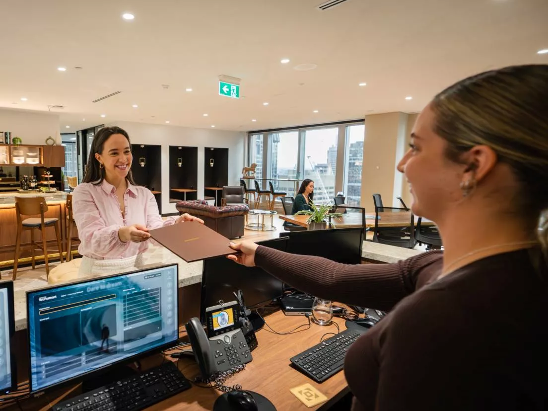 Client receiving files from a receptionist in Servcorp Chifley Tower