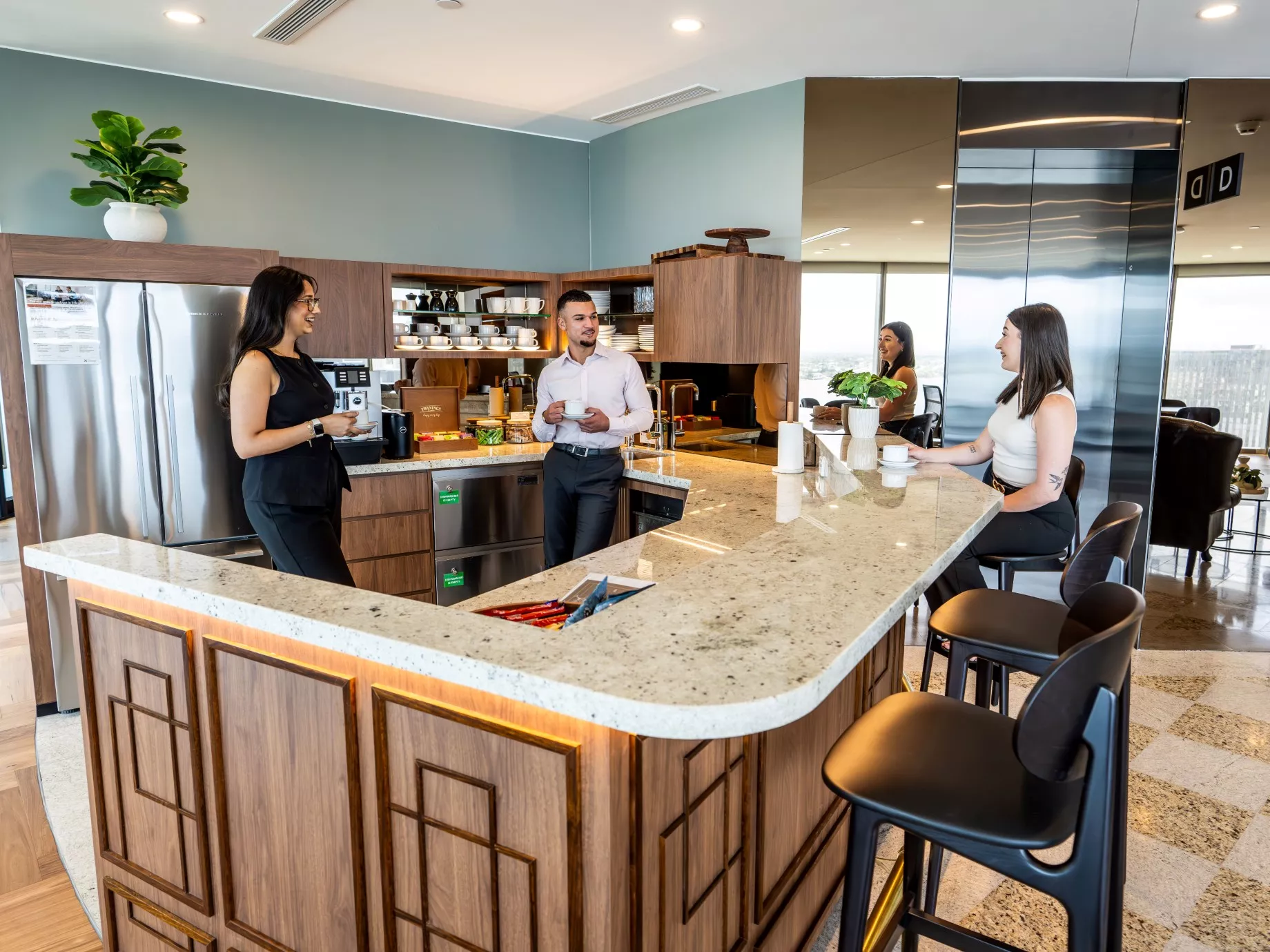 Clients enjoying the fully stocked kitchen in Servcorp Capital Square Tower 3 Perth