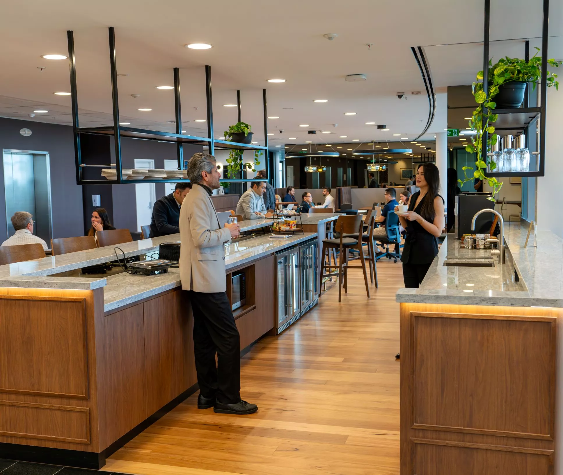 Clients catching a coffee break the newly renovated modern coworking space and enjoying the lounge in Servcorp Avaya House, Macquarie Park
